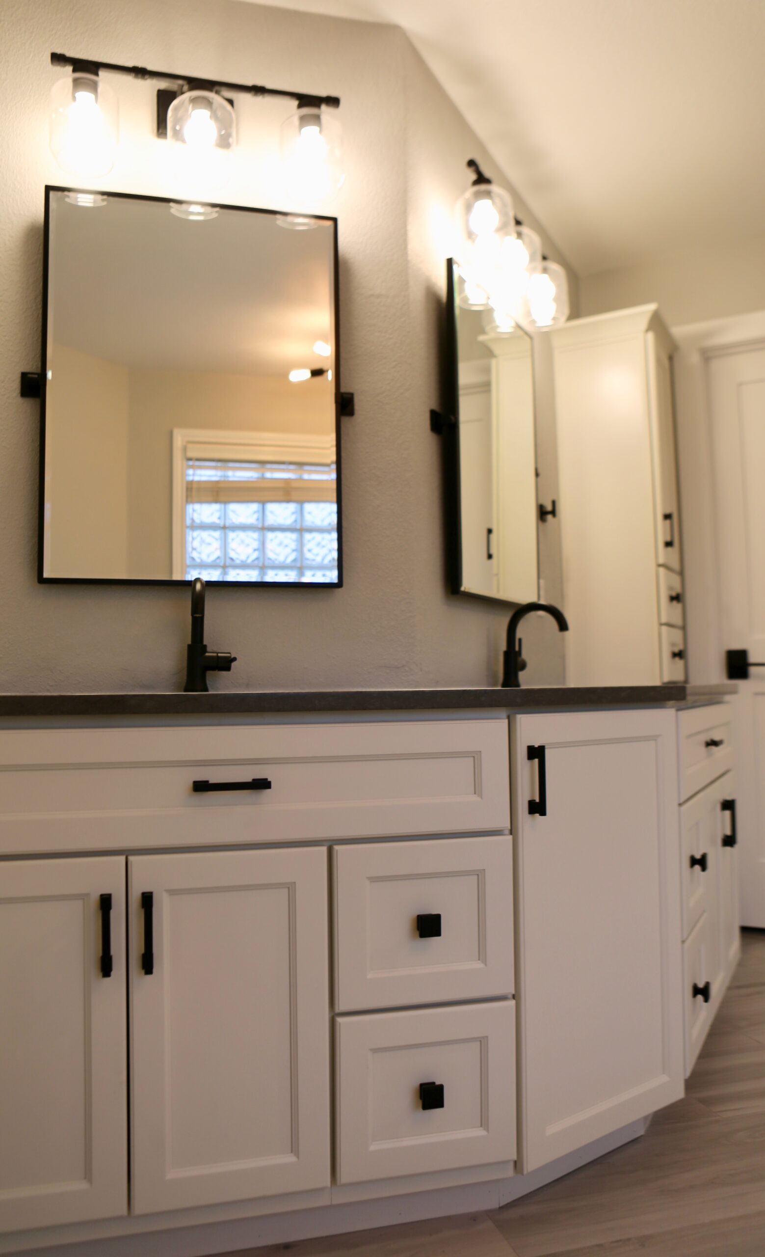 White double sink vanity with black fixtures in a modern bathroom